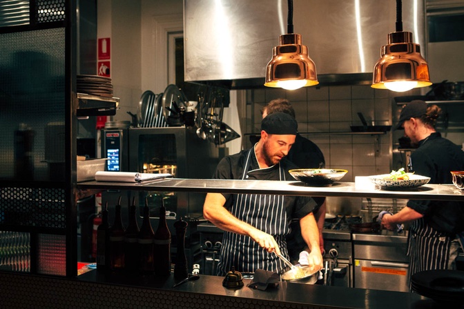 Chef preparing a meal in a bustling kitchen