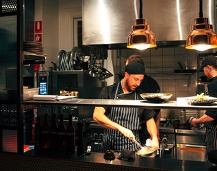 Chef preparing a meal in a bustling kitchen