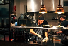 Chef preparing a meal in a bustling kitchen
